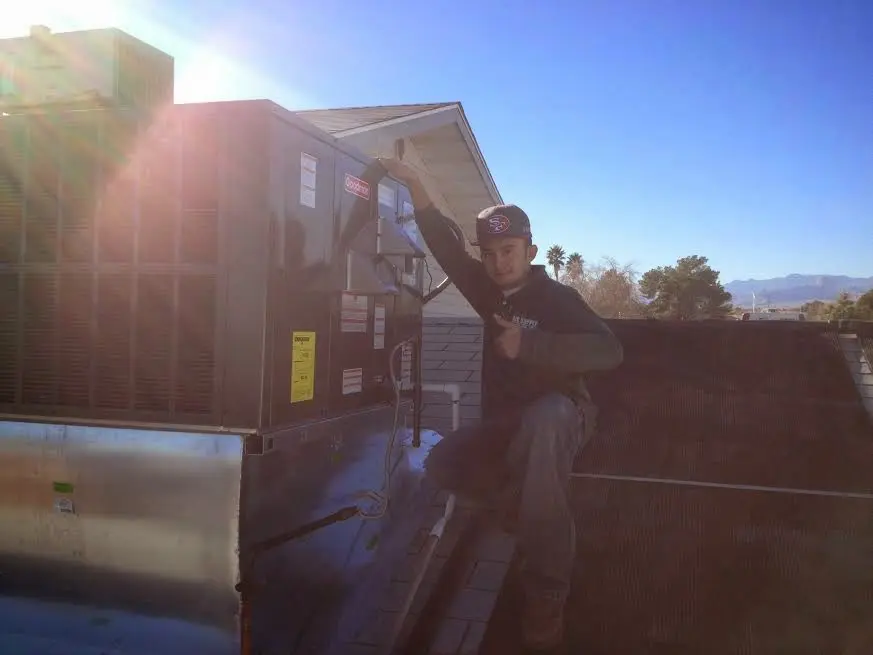 HVAC technician performing HVAC Inspection on a rooftop unit in Calhoun